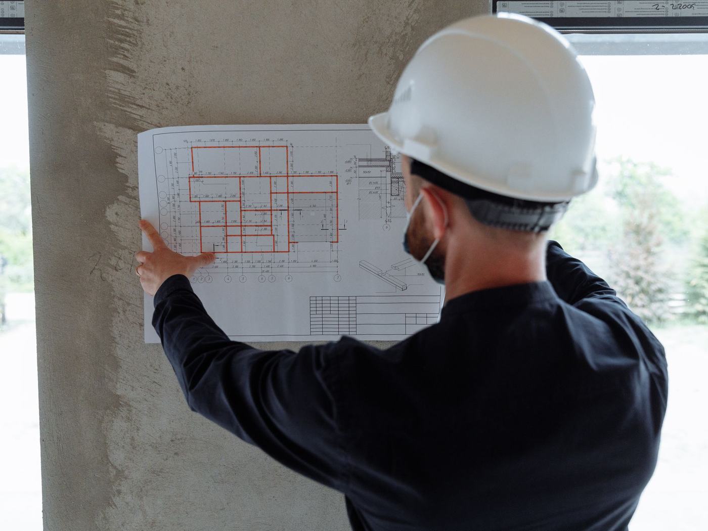 Engineer reviewing a structural plan on site